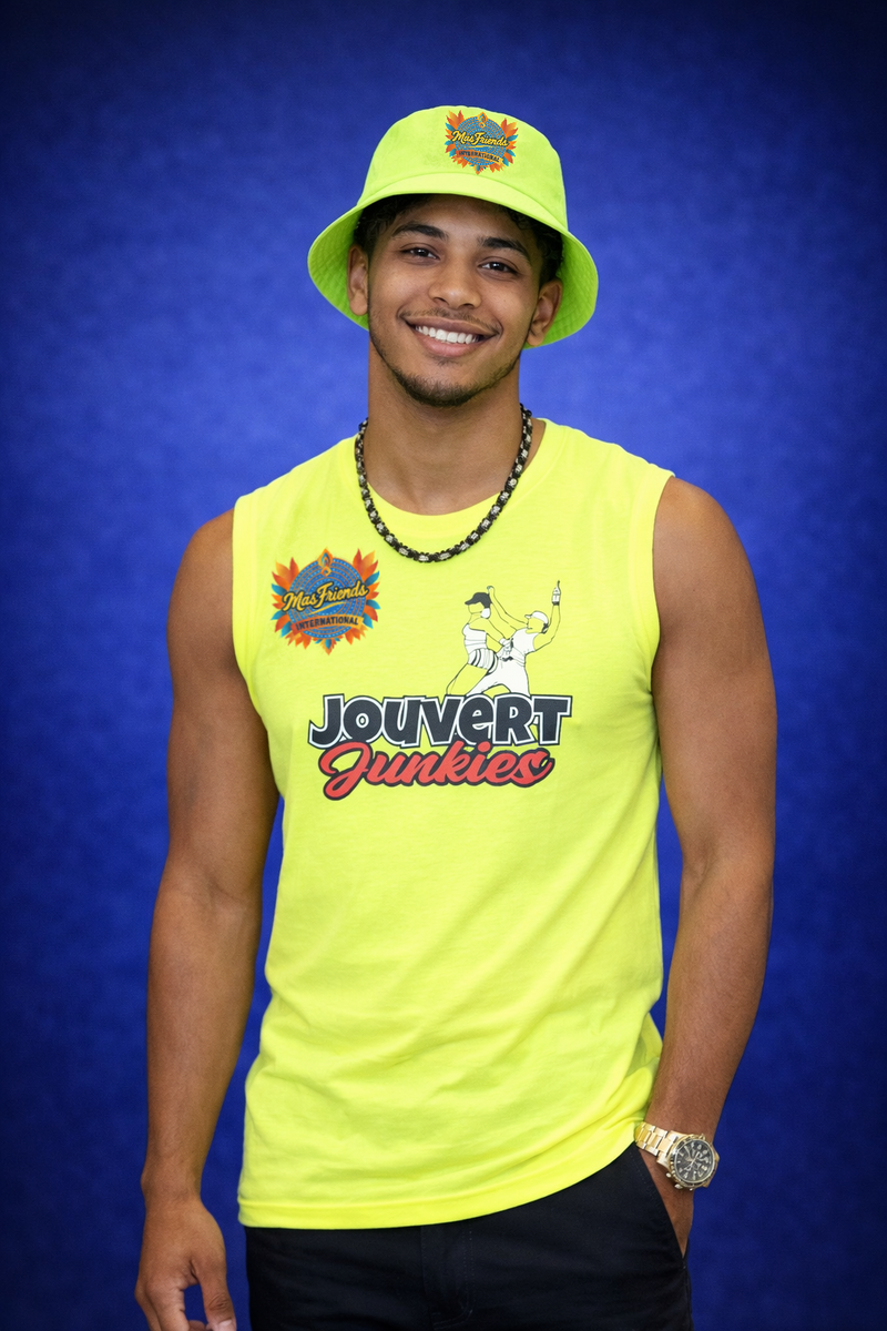 Person wearing a bright yellow sleeveless shirt with 'Jouvert Junkies' logo and matching hat against a blue background